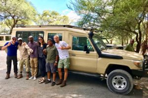 German tour group in front of a safari car in Tanzania