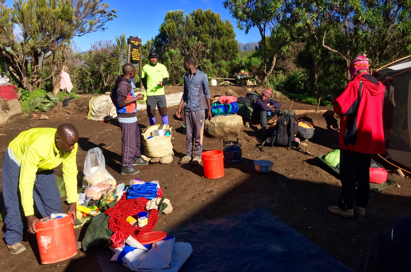 Leaving a camp in the morning and porters packing