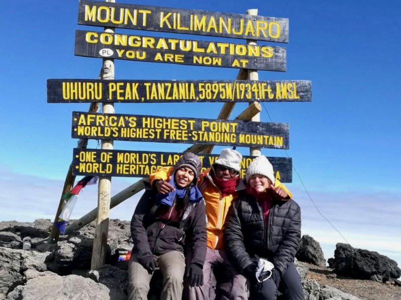 Two mountaineers at the summit of Kilimanjaro