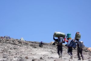 Carrier on the way to the summit of Kilimanjaro