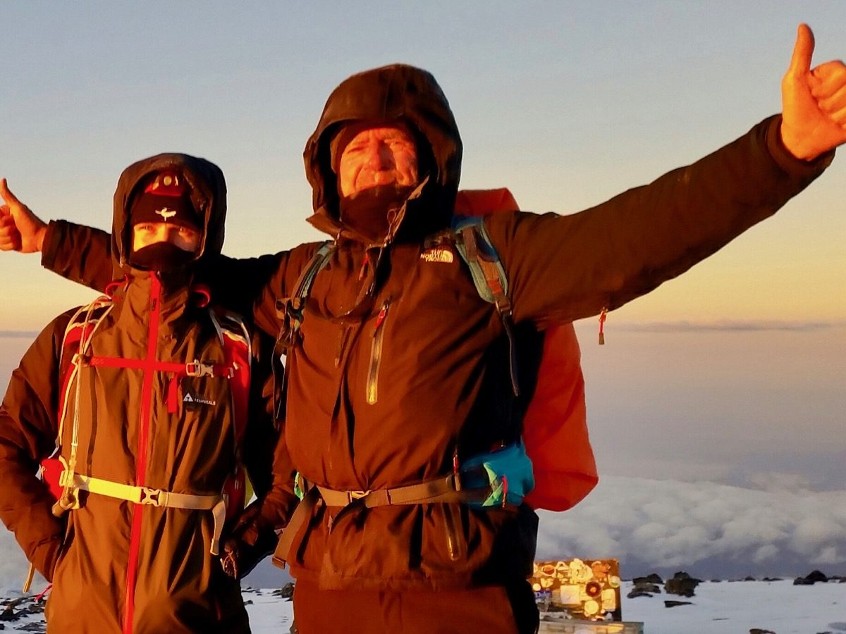 Two summit climbers on the summit of Kilimanjaro